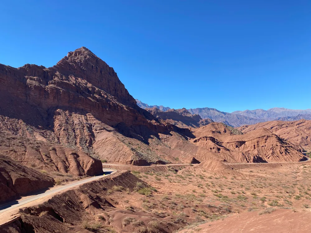 Red rock landscape beneath a blue sky along Route 68 in Salta, Argentina