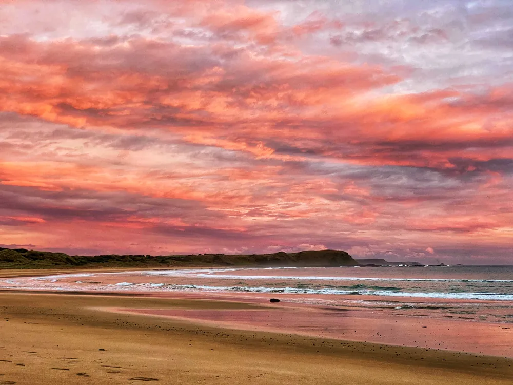 Pink evening sky reflected along Summerlands Beach, Victoria